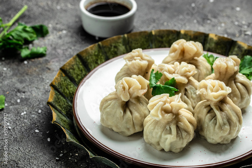 Georgian dumplings Khinkali with meat and spicy sauce. banner, menu, recipe place for text, top view