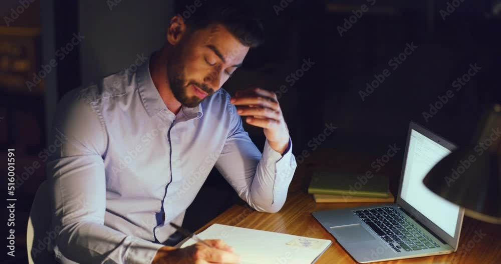 Stressed business man working late on a laptop in an office at night. Young worried entrepreneur feeling tired while struggling with burnout, eye strain and a headache from deadlines and pressure