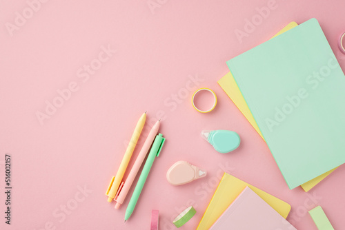 Back to school concept. Top view photo of colorful stationery diaries pens round correction tape ruler and adhesive tape on isolated pink background