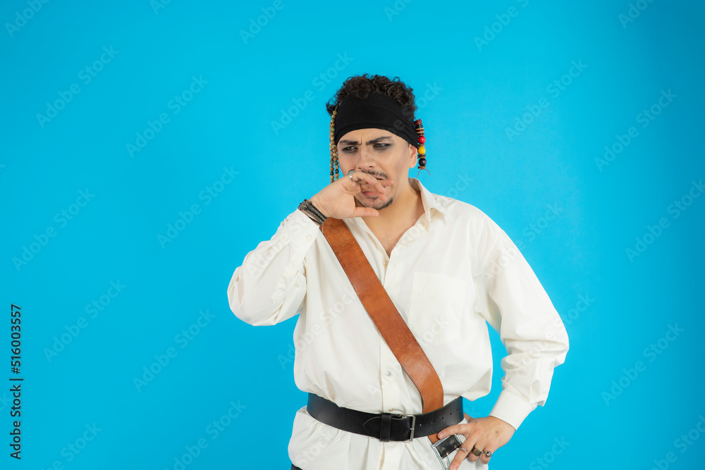 Thoughtful young pirate put hand to his mouth and feeling sad Thoughtful young pirate put hand to his mouth and feeling sad