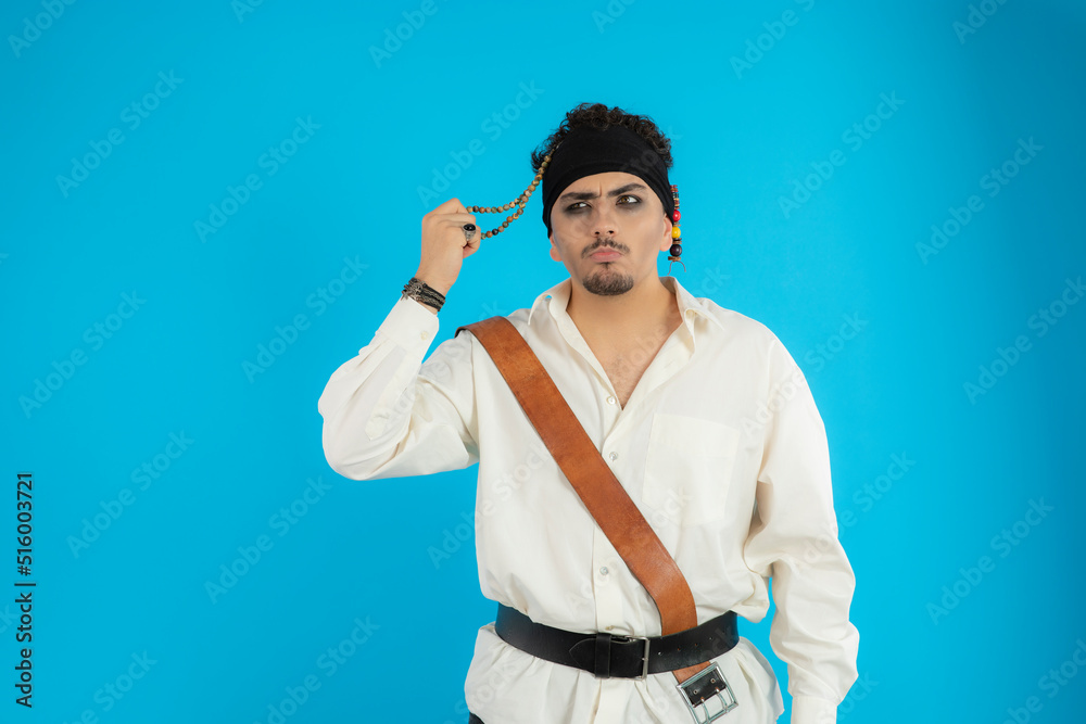 Thoughtful young pirate straighten his hair and thinking Thoughtful young pirate straighten his hair and thinking