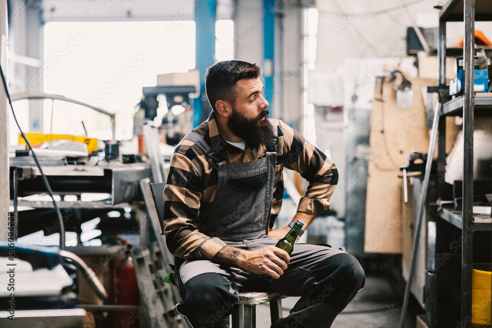 An industry worker checking on bus construction in vehicle production factory.