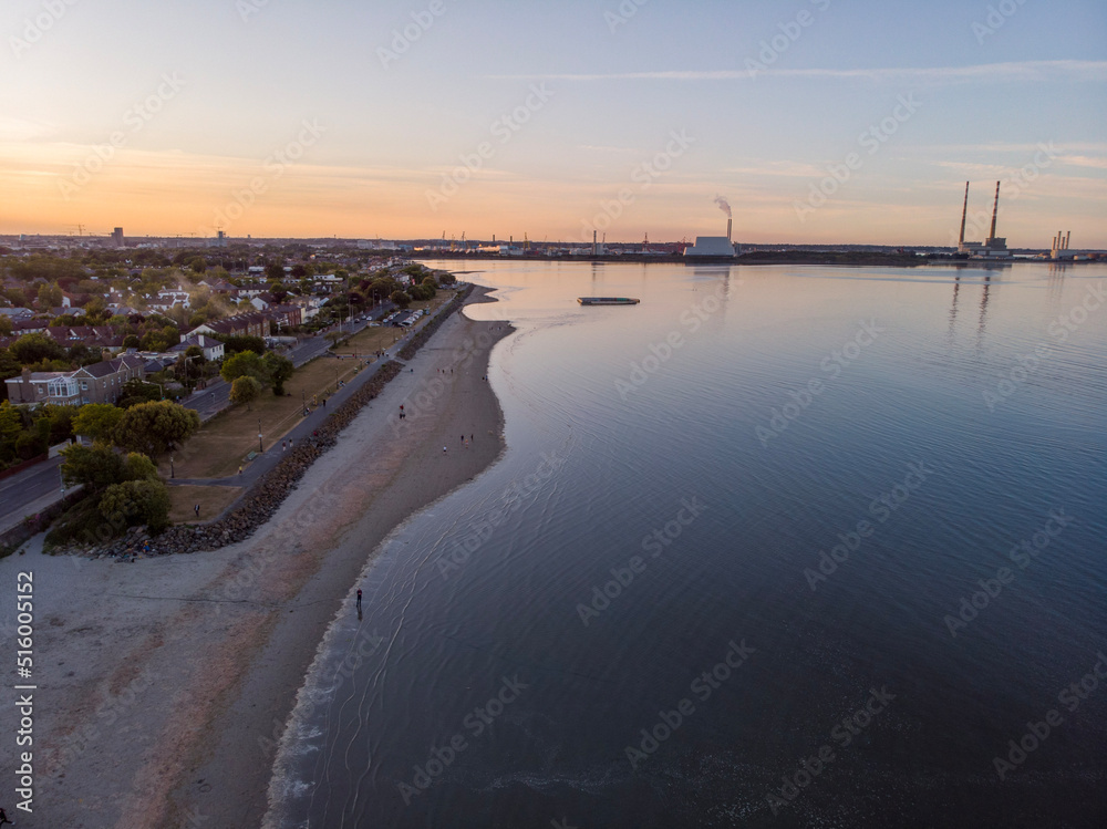 Aerial view of a sunset over a beach in Dublin with the famous chimney