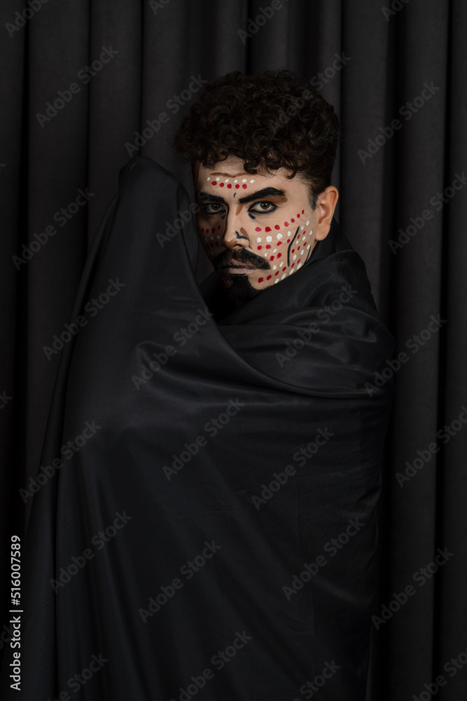 Vertical photo of young warrior in black cape Vertical photo of young warrior in black cape