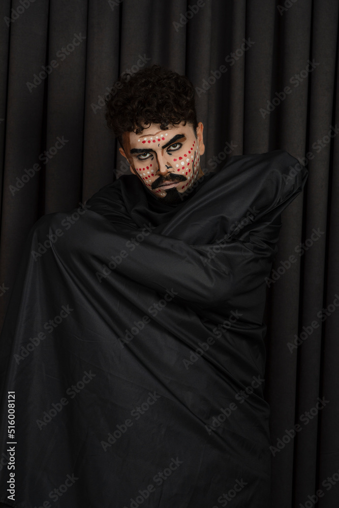 Vertical photo of young guy with creative makeup in black