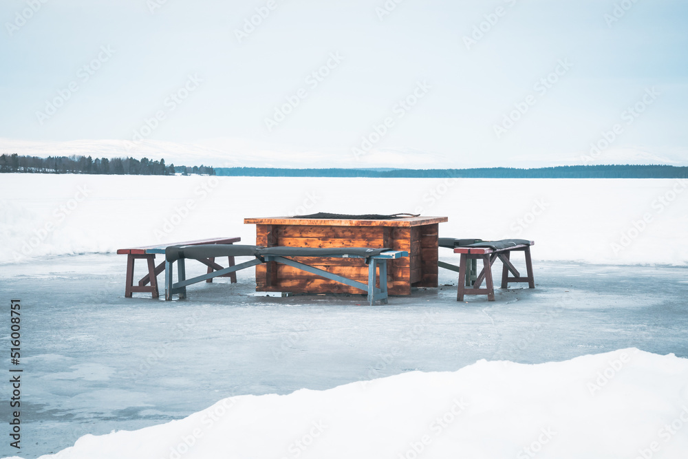 Bonfire place with wooden benches on ice skating track called Bonfire place with wooden benches on ice skating track called