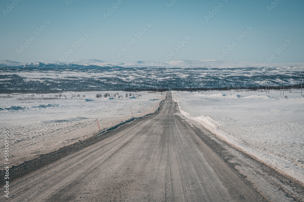 Roadtrip on Flatruet - Sweden's highest backcountry road to mountain. Winter times on gravel road. Endless straight highway to valley. Copy space. Useable as background. Roadtrip on Flatruet - Sweden's highest backcountry road to mountain. Winter times on gravel road. Endless straight highway to valley. Copy space. Useable as background.