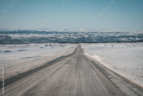Roadtrip on Flatruet - Sweden s highest backcountry road to mountain. Winter times on gravel road. Endless straight highway to valley. Copy space. Useable as background.