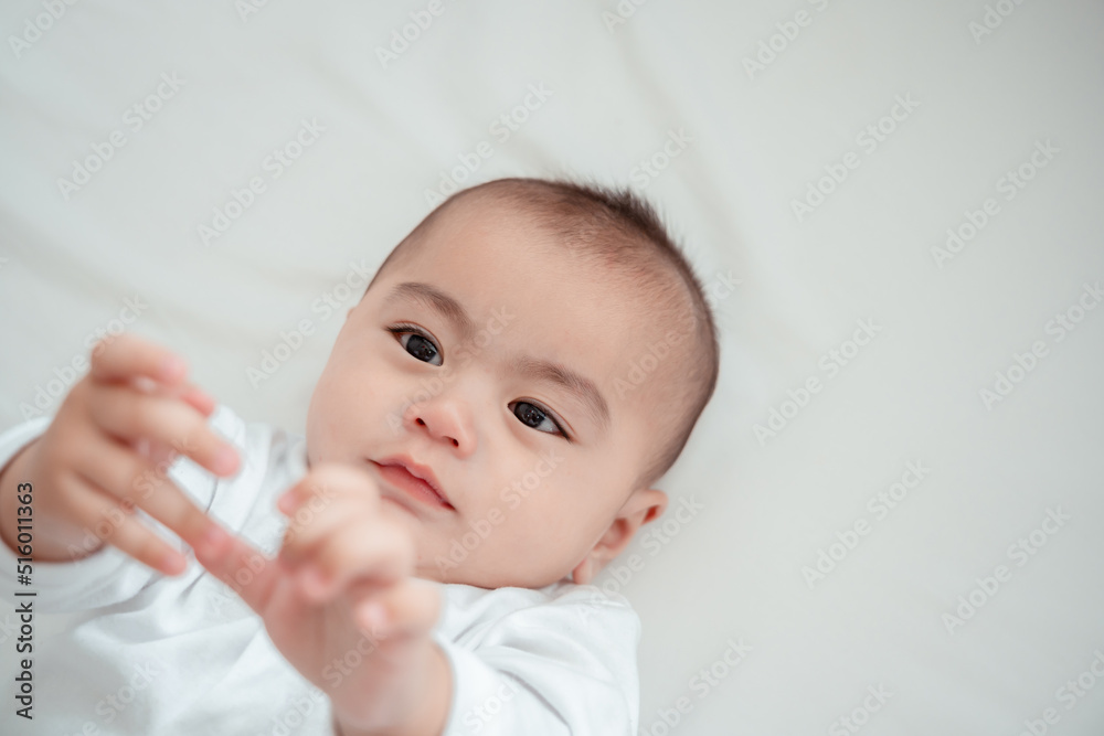 Smiling of newborn baby or cute little lying on a white bed at home. Infant child portrait happy concept, Healthy childcare in the morning. Smiling of newborn baby or cute little lying on a white bed at home. Infant child portrait happy concept, Healthy childcare in the morning.