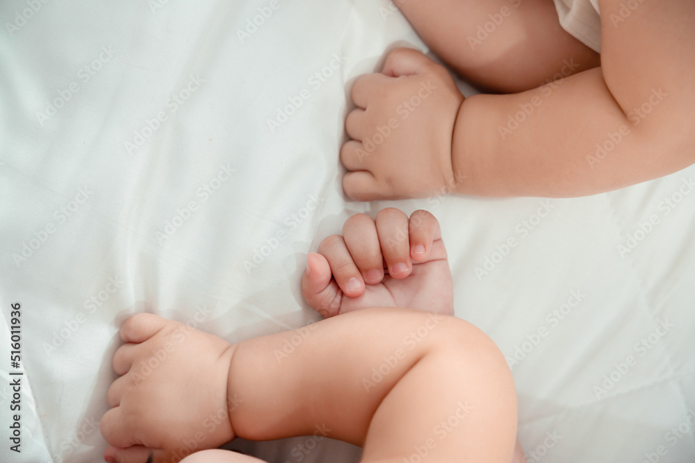 Closeup hands of newborn twin baby or cute little lying on a white bed at home. Infant child portrait happy concept, Healthy childcare in the morning. Closeup hands of newborn twin baby or cute little lying on a white bed at home. Infant child portrait happy concept, Healthy childcare in the morning.