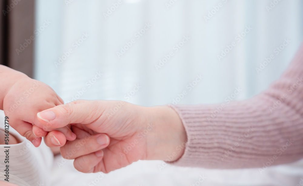 Hands holding of mother parent soft touch newborn baby fingers love family concept. Infant child portrait happy healthy. Hands holding of mother parent soft touch newborn baby fingers love family concept. Infant child portrait happy healthy.