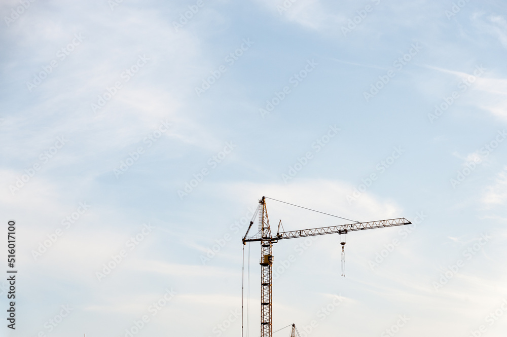 Construction crane on the sky background