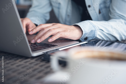 Woman hands typing on laptop keyboard on table at office. Female freelancer online working on computer, browsing the internet at coffee shop, distance job, remotely work, telecommuting