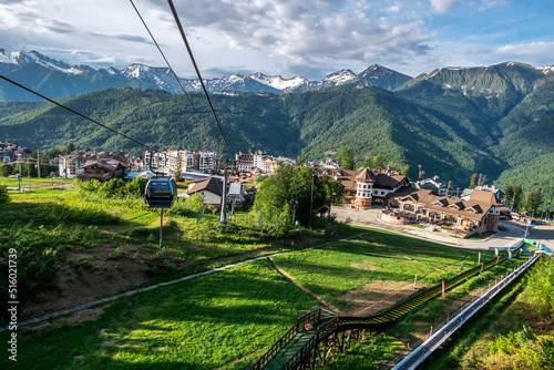 Cable car cabin rises up from Rosa Khutor village to Roza Peak mountain in Sochi resort.
