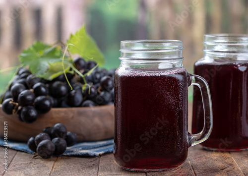 Obraz na plátně Glass of grape juice with rural background