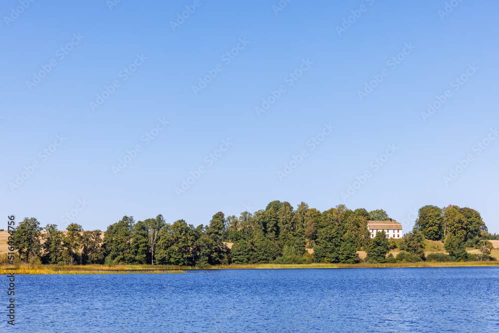 House on a hill by a lake