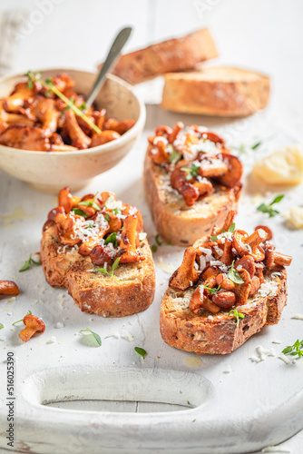 Homemade and tasty toasts with chanterelles, parmesan cheese and herbs.