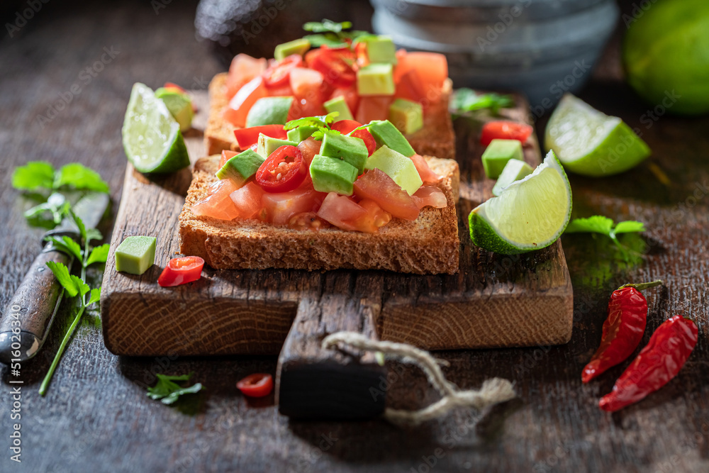 Homemade and tasty toasts with tomatoes, lime and coriander. Homemade and tasty toasts with tomatoes, lime and coriander.