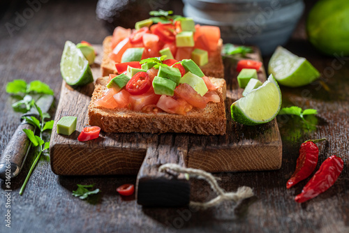 Homemade and tasty toasts with tomatoes, lime and coriander.