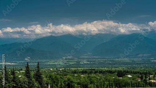Time lapse mountain landscape with moving clouds at sunny summer day