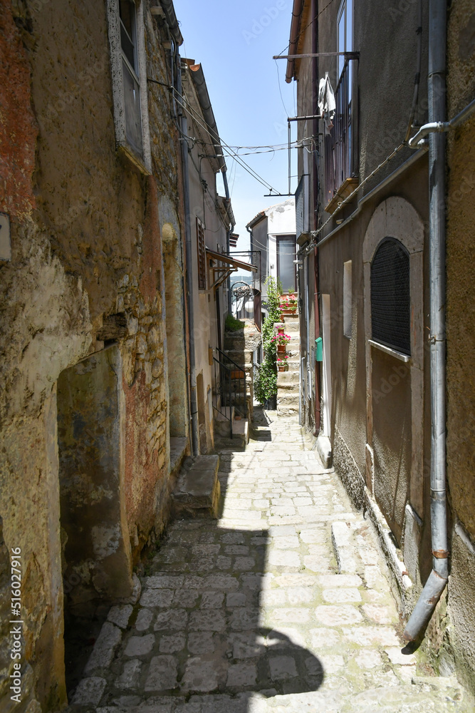A narrow street between the old houses of Pietragalla, a village in the Basilicata region, Italy. A narrow street between the old houses of Pietragalla, a village in the Basilicata region, Italy.