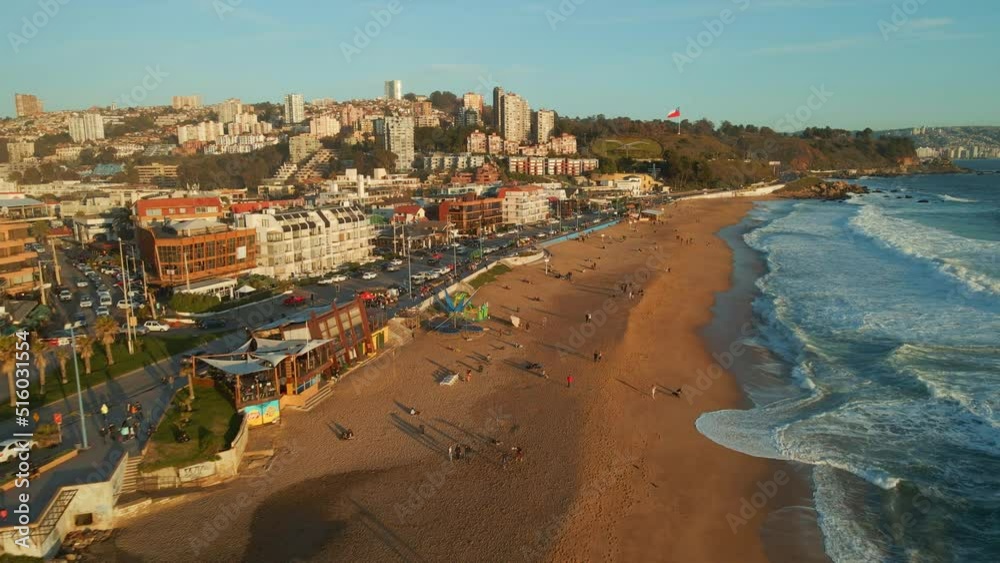 Aerial view flying over Reñaca golden Chile scenic sandy beach waterfront above ocean waves Aerial view flying over Reñaca golden Chile scenic sandy beach waterfront above ocean waves