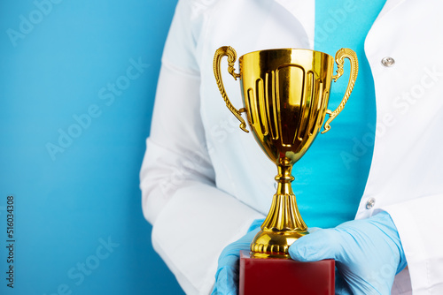 doctor holds a cup in his hands, a professional medical award photo