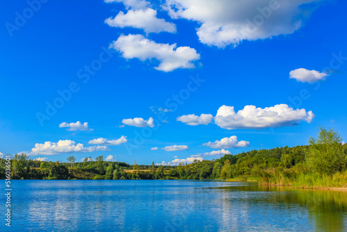 Beautiful quarry lake dredging pond lake blue turquoise water Germany.