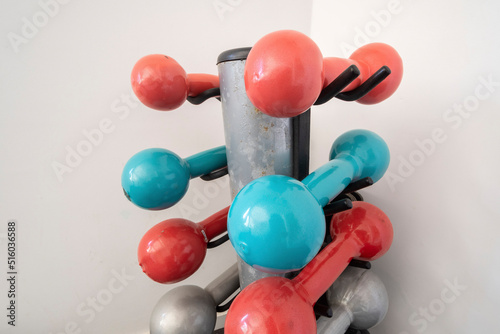 assorted colored isolated dumbbell on stand