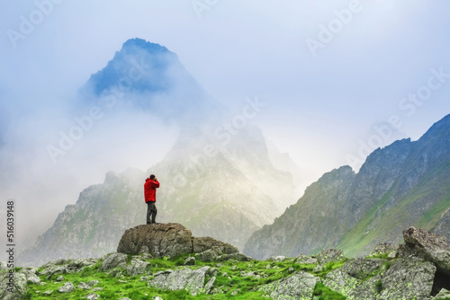 Hiker photographer on top of High Tatras mountain in Slovakia. © serkucher