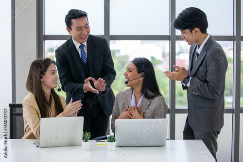 The supervisor compliments and encourage the employees in the office, business concept.
