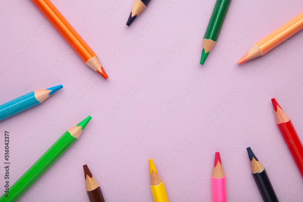 Color pencils on purple background. Close up. Color pencils on purple background. Close up.