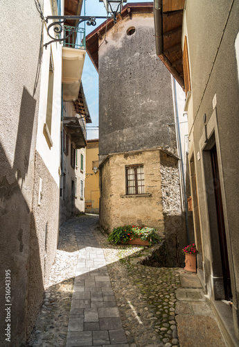 Fototapeta Naklejka Na Ścianę i Meble -  Narrow cobblestone streets with stone houses in the small ancient village Naggio in the province of Como, Lombardy, Italy