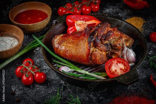 Pork roast roll on a dark stone table garnished with cherry tomatoes. Porchetta, a delicious pork roast from the Italian culinary holiday tradition. Fast food restaurant, delivery service.
