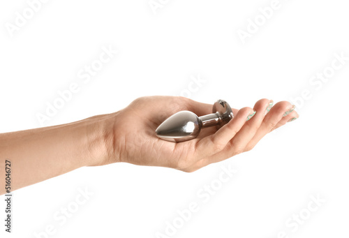 Female hand with anal plug from sex shop on white background
