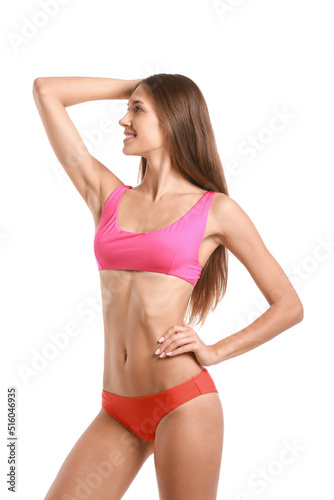 Young tanned woman in swimsuit on white background