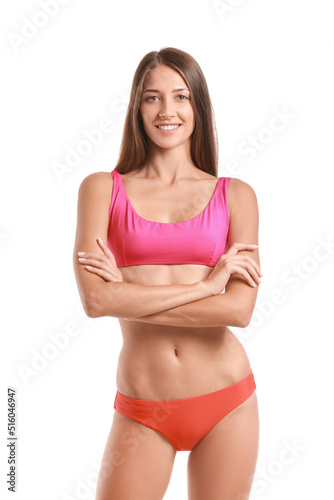 Young tanned woman in swimsuit on white background