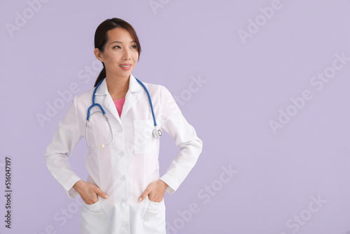 Female Asian doctor on lila...