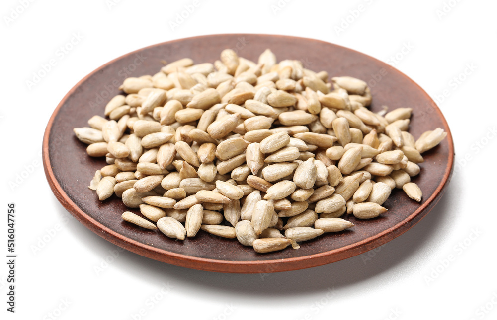 Plate with peeled sunflower seeds on white background Plate with peeled sunflower seeds on white background