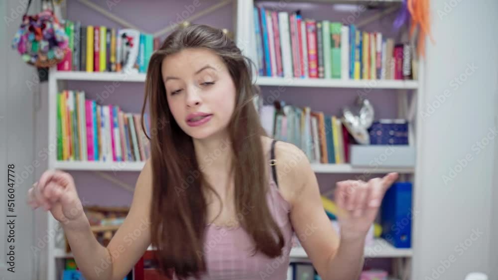 The girl sings vigorously while gesturing with her hands. The girl sings vigorously while gesturing with her hands.