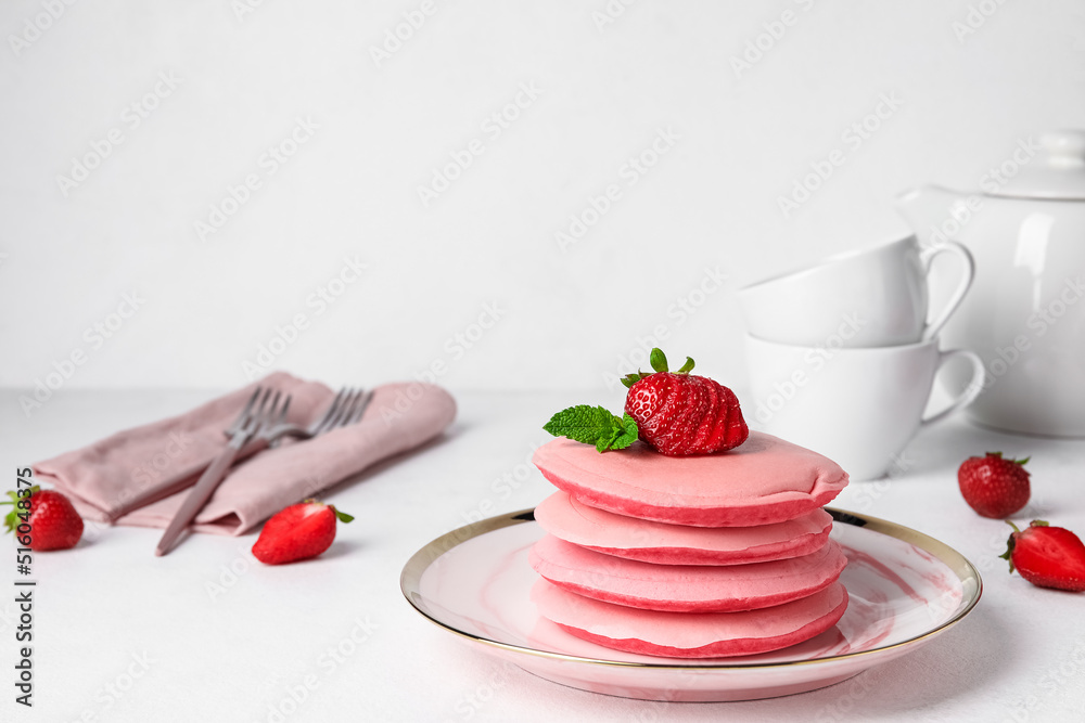 Plate of tasty pink pancakes on light background Plate of tasty pink pancakes on light background