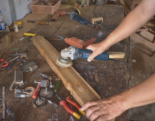 Carpenters, wood polishers, sanders, cutting boards and other equipment. Inside the old room of Asian craftsmen.Professional carpenter in joiner's shop. Concept of woodworking and craftsmanship