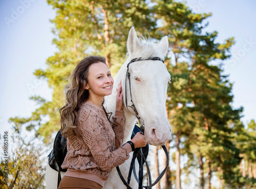portrait of young smiling woman with white blue eyes horse