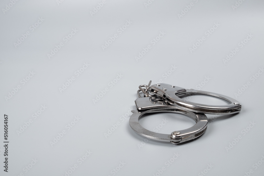handcuffs on a black background close-up, arrest detention copy space. handcuffs on a black background close-up, arrest detention copy space.