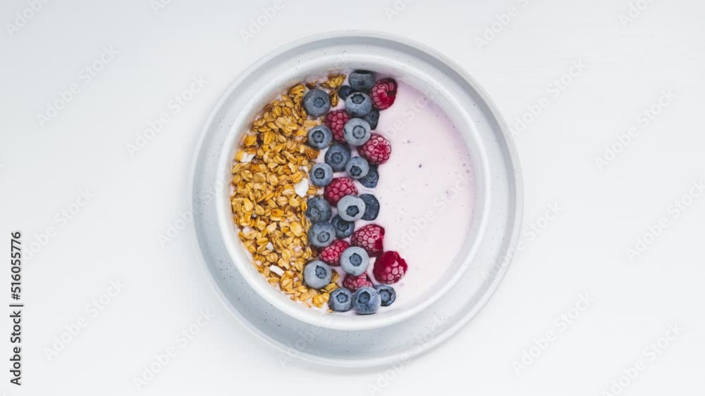 Smoothie bowls with granola, blueberries and raspberries on a white background. Healthy breakfast step by step - Stop Motion Animation Smoothie bowls with granola, blueberries and raspberries on a white background. Healthy breakfast step by step - Stop Motion Animation