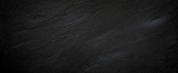 Black or dark gray rough grainy stone or sand texture background