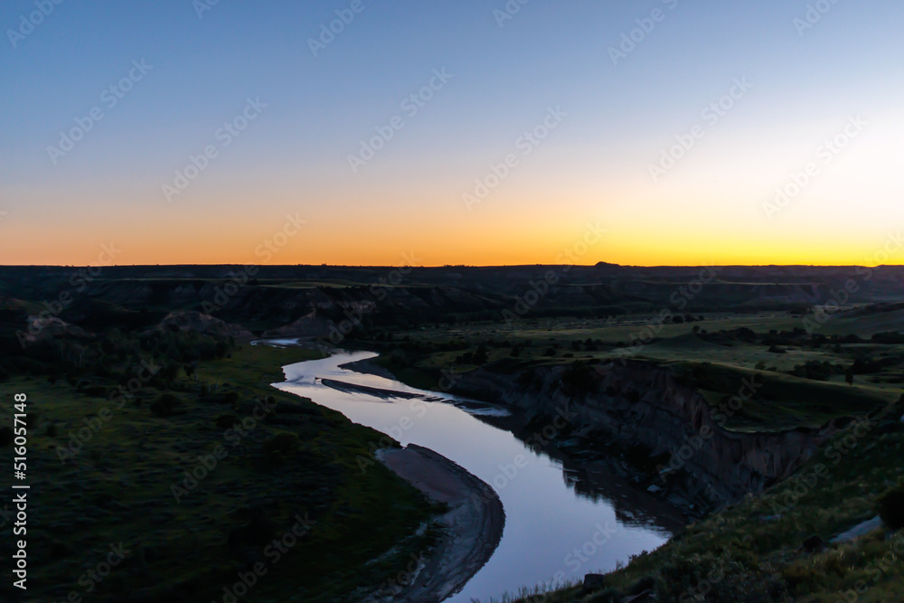 The sunsets over the Missouri River at dusk at Theodore Roosevelt National Park in North Dakota