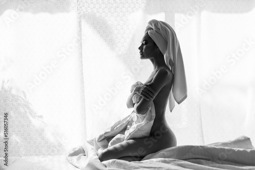 Asian nude woman on bed with blanket cover body in morning photo
