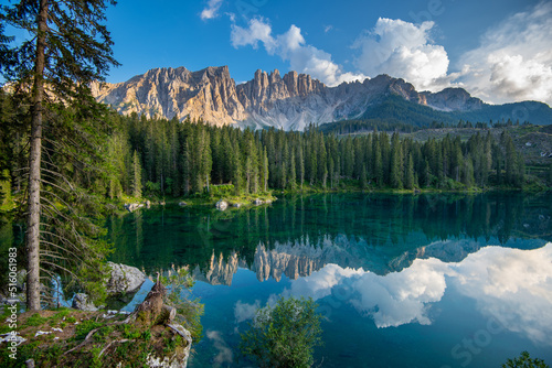 Paradise landscape at Karersee (Lago di Carezza, Lake Carezza) in the Dolomites of Italy at Mount Latemar, province of Bolzano, south tyrol. Blue and crystal clear water. Tourist destination of Europe photo