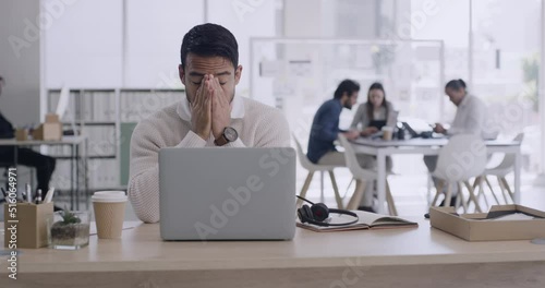 Overworked male call center agent suffering from a headache after a call online. Customer support worker looking stressed while talking to people. Helpline advisor looking tense after a difficult day photo